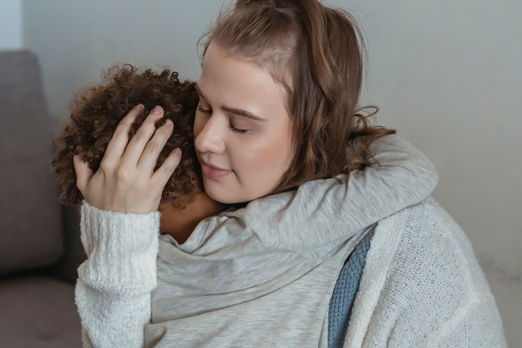 Mother comforting her young child from his fears.