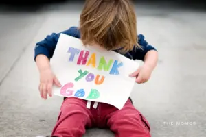 Young boy giving thanks.